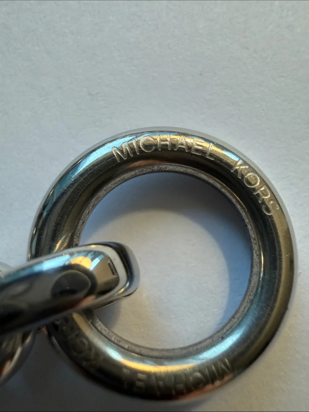 Michael Kors Silver-tone Toggle Bracelet with Dual Sided Logo Charm.